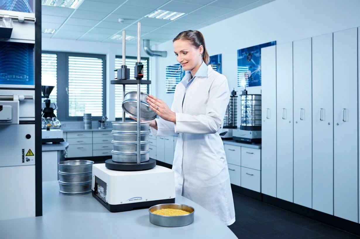 Scientist using a AS 200 Control sieve shaker in a laboratory