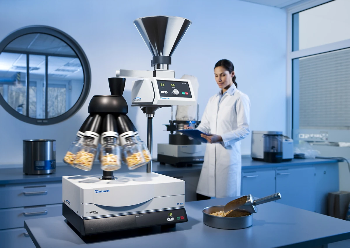 PT 100 sample divider in a lab with a technician